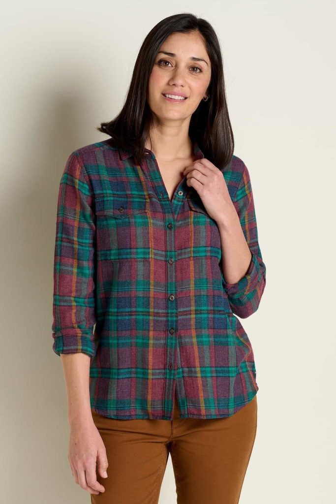 A woman wearing an organic flannel shirt from an affordable sustainable fashion brand called Toad & Co.
