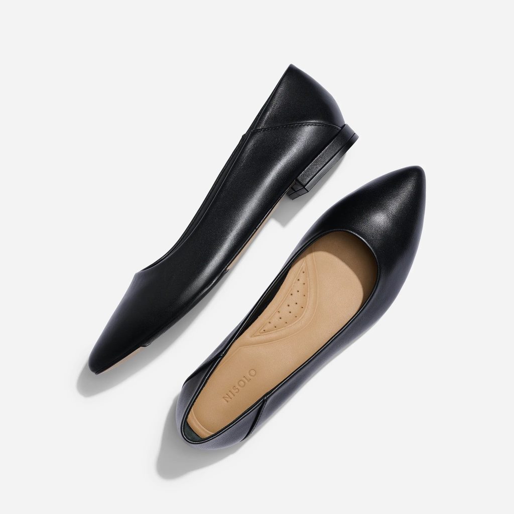 A pair of black ethical leather flats from Nisolo for sustainable capsule wardrobe shoes