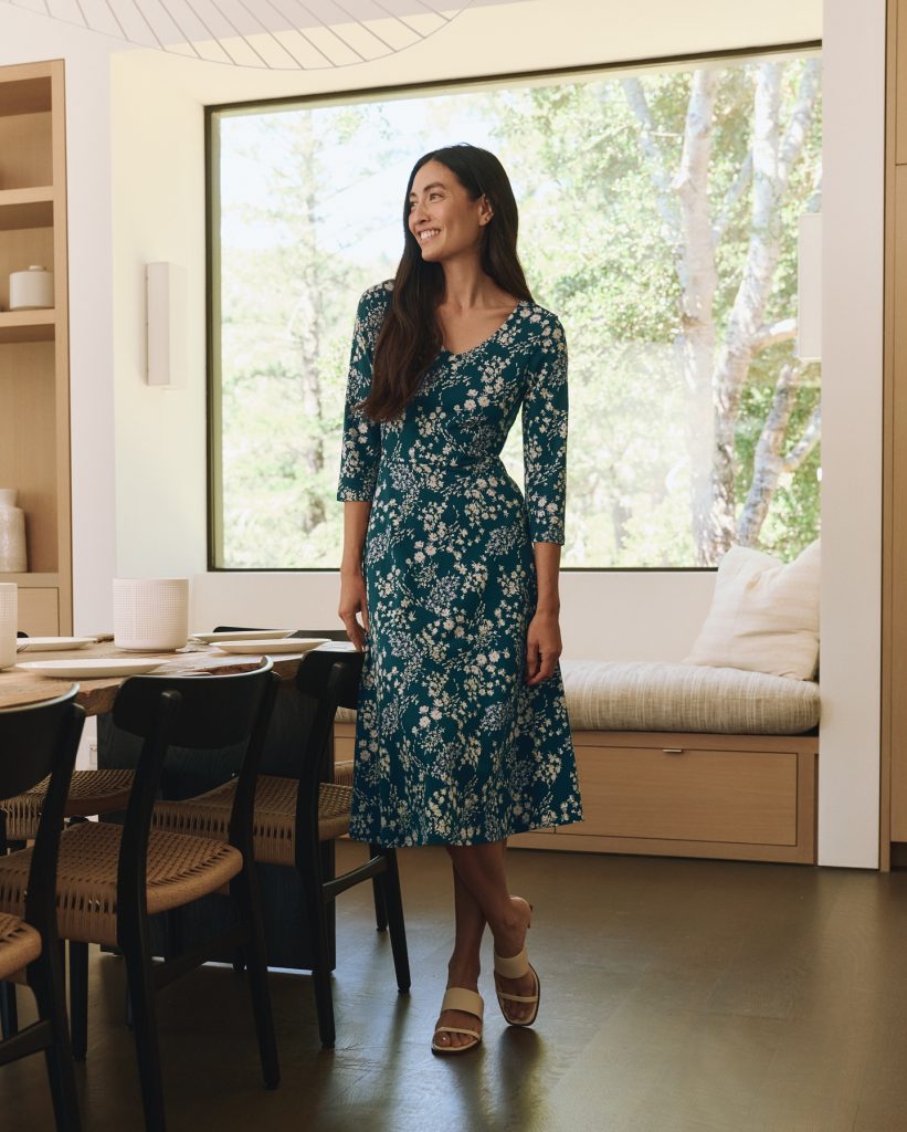 A woman wearing an affordable organic cotton dress from sustainable clothing brand Pact.