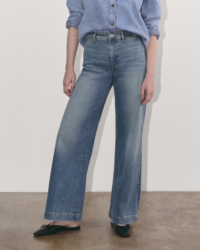 a woman wearing a pair of wide leg sustainable jeans from everlane 