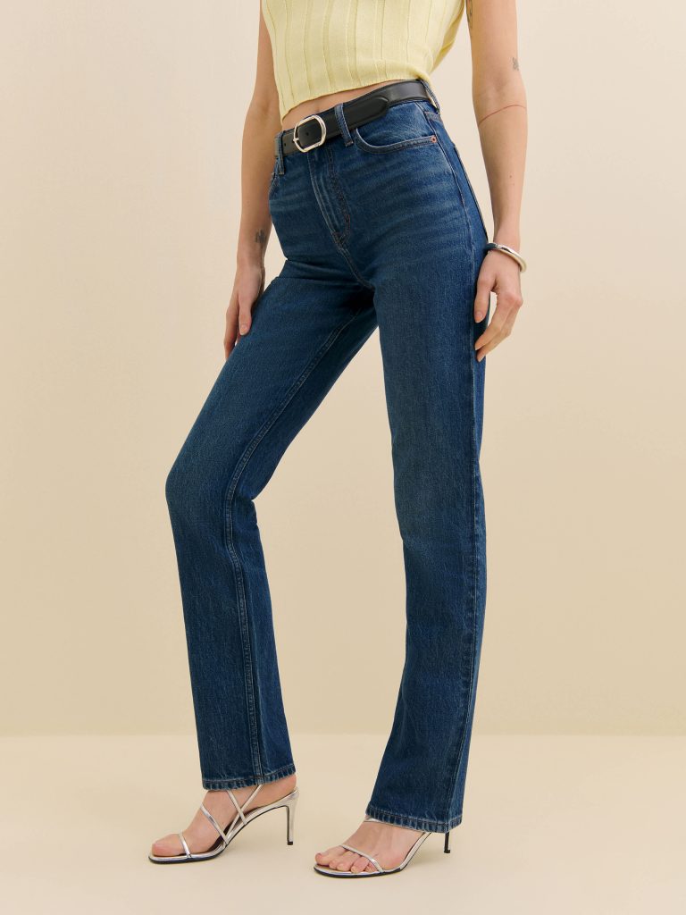 a woman wearing a pair of dark blue sustainable jeans 
