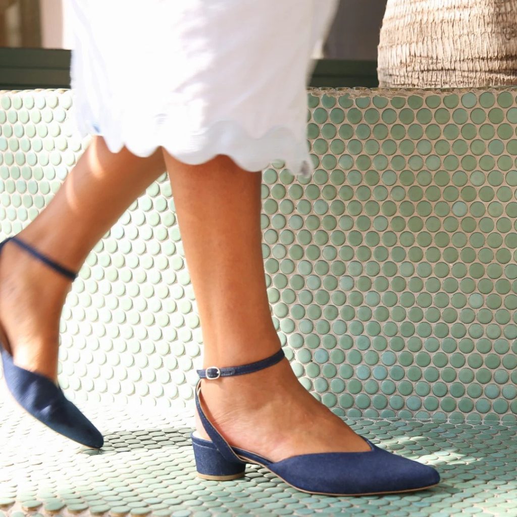 a woman wearing a pair of interchangeable shoes from a brand that empowers women, alterre 