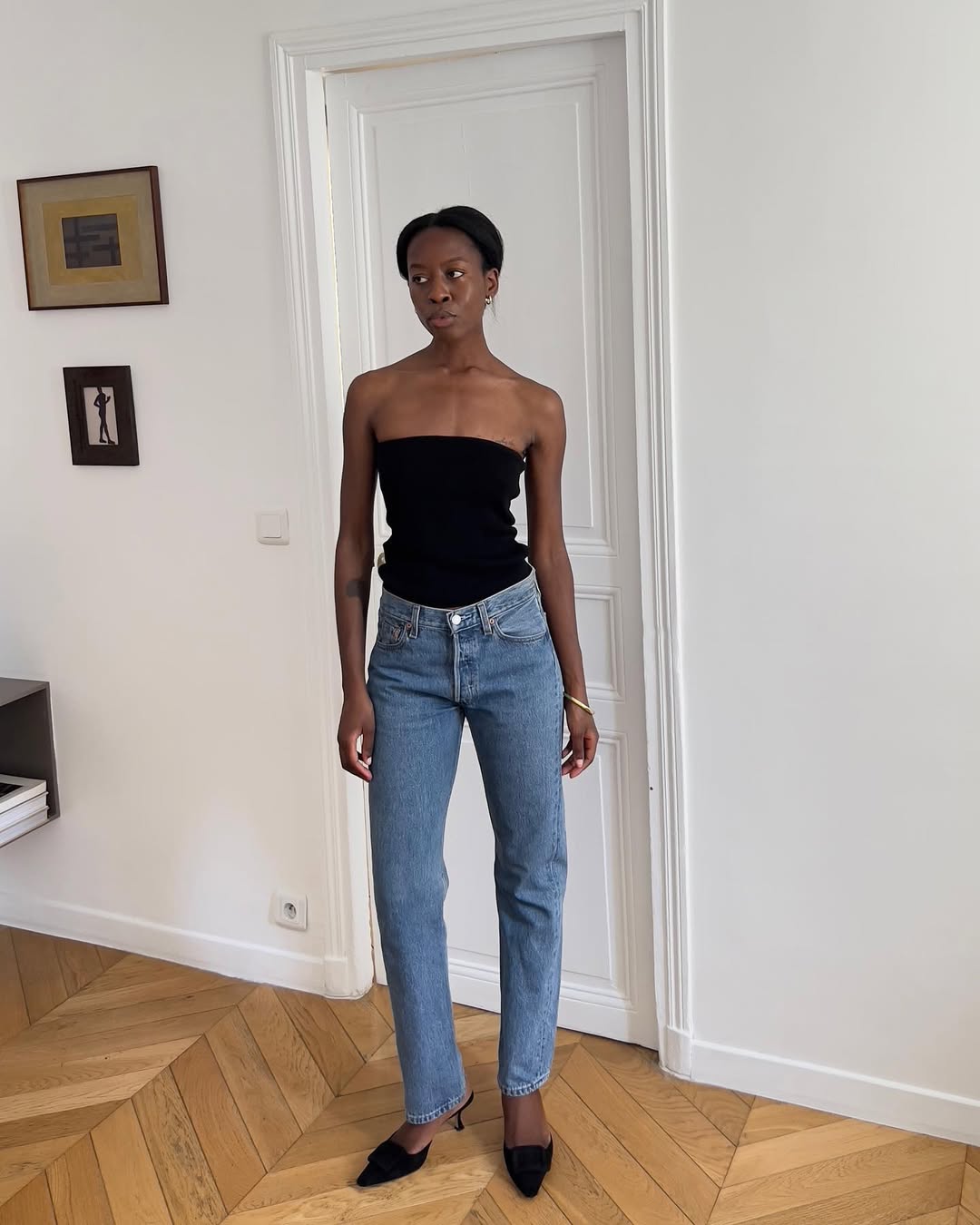 woman wearing black tube top and high-waisted jeans