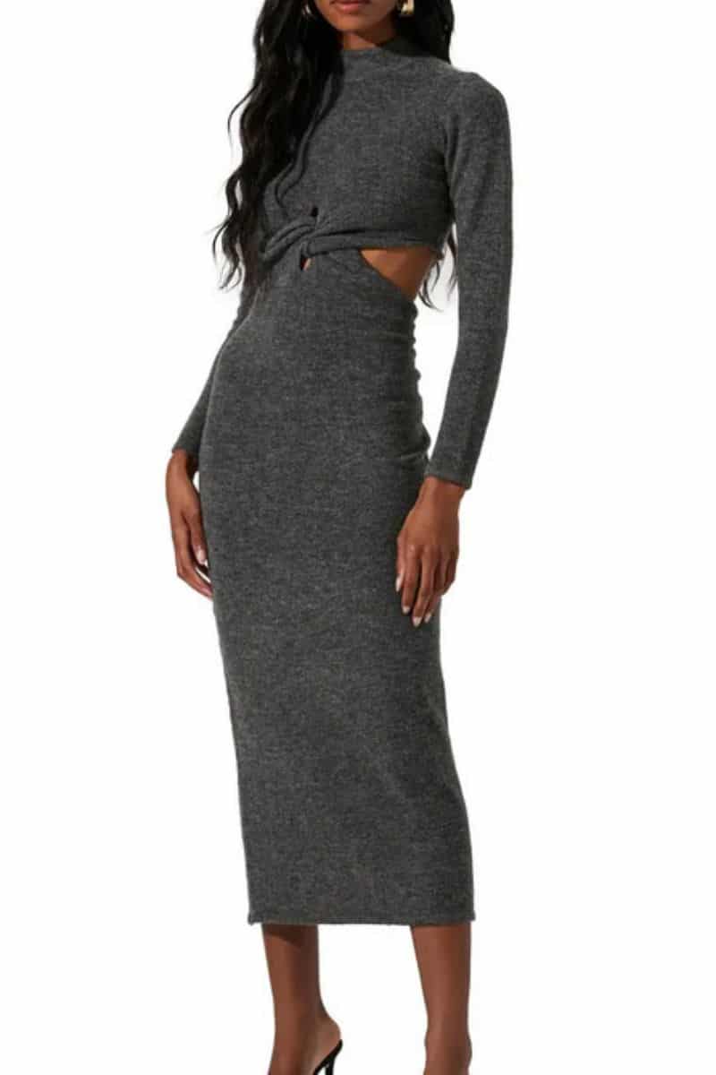 Model wears gray sweater dress with side cutouts.