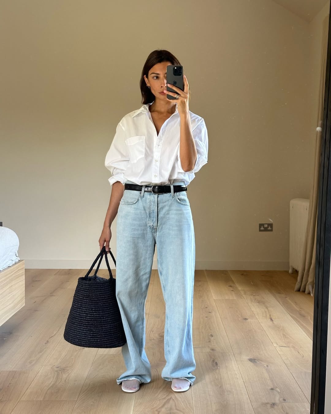 woman wearing white button-down shirt and loose jeans with belt
