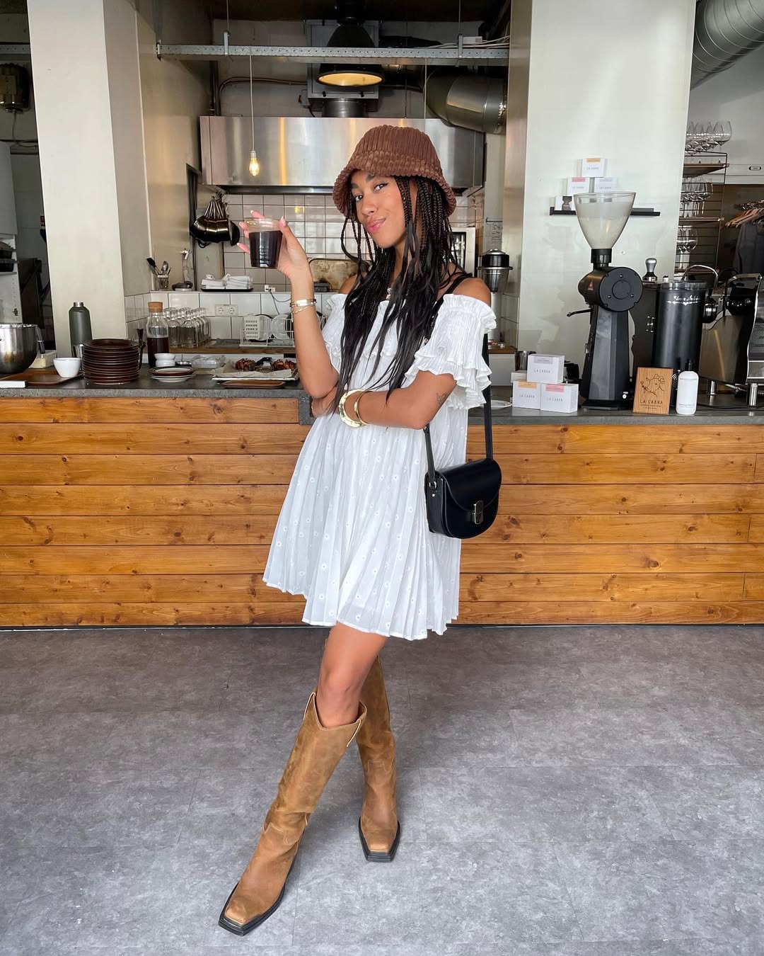 woman wearing white dress with tall boots in nyc summer outfit