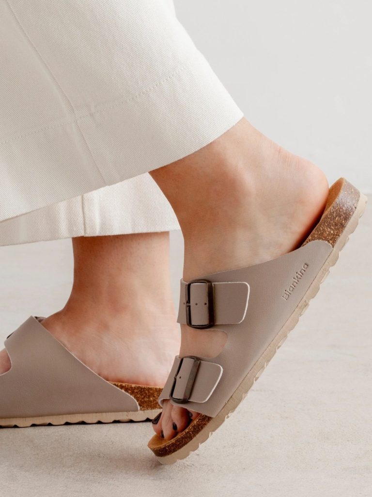 A woman's feet in a pair of ethical sandals from Biankina that look like a sustainable alternative to Birkenstock