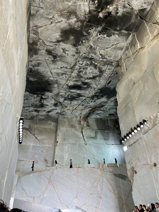 The finale walk at COS's S/S 25 show in a marble quarry outside of Athens, Greece.