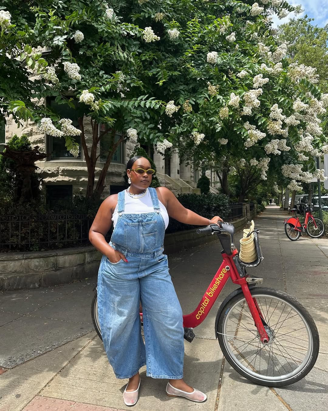 woman wearing denim overalls and white tank and white ballet flats
