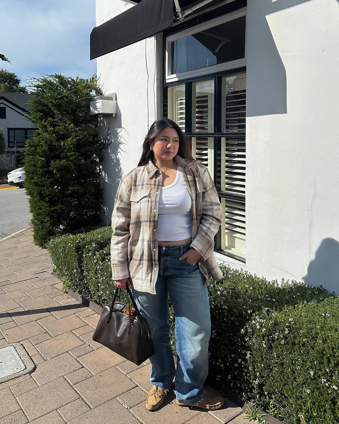 woman wearing loose jeans and white tank with plaid button-down shirt and loafers
