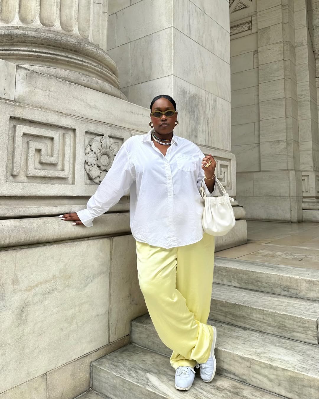 Woman wearing white button-down shirt and yellow pants in a summer 2025 outfit.