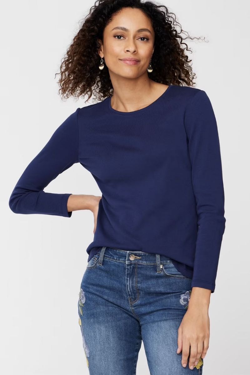 Model wears navy scoop neck t-shirt, part of our fall clothing checklist. 