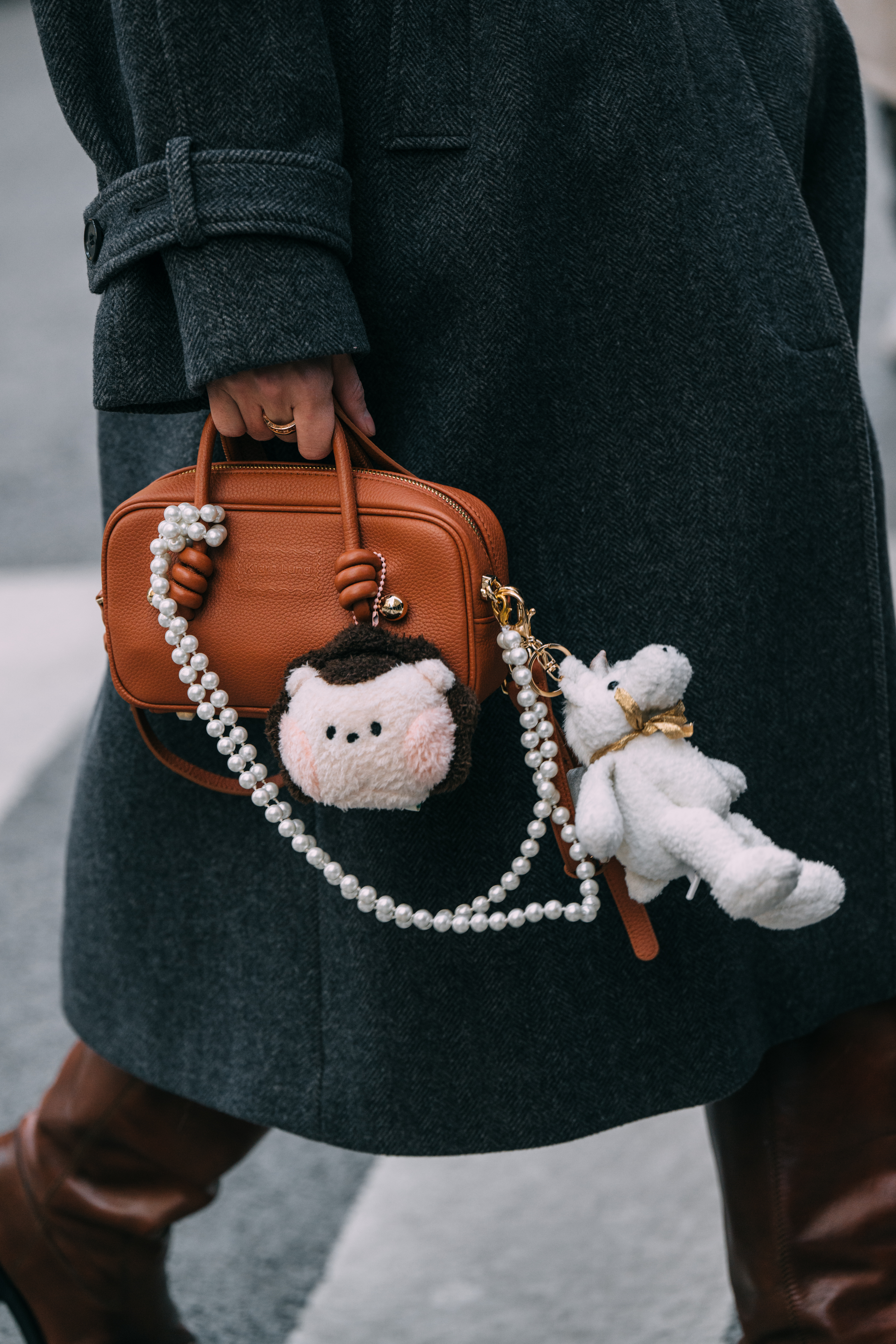 Photo of woman wearing bag charms and designer handbag in Tokyo.