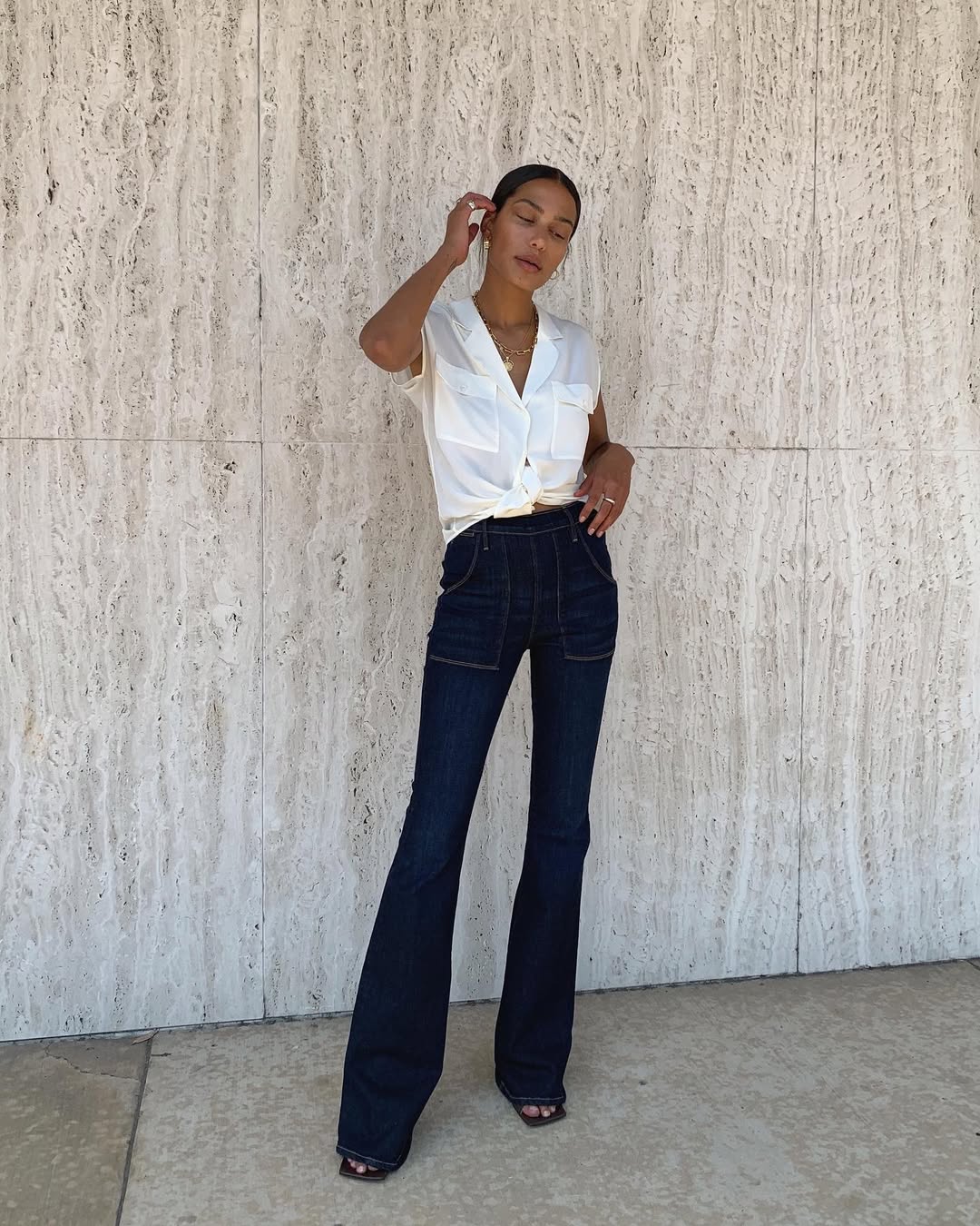 woman wearing flare jeans with white button-down shirt