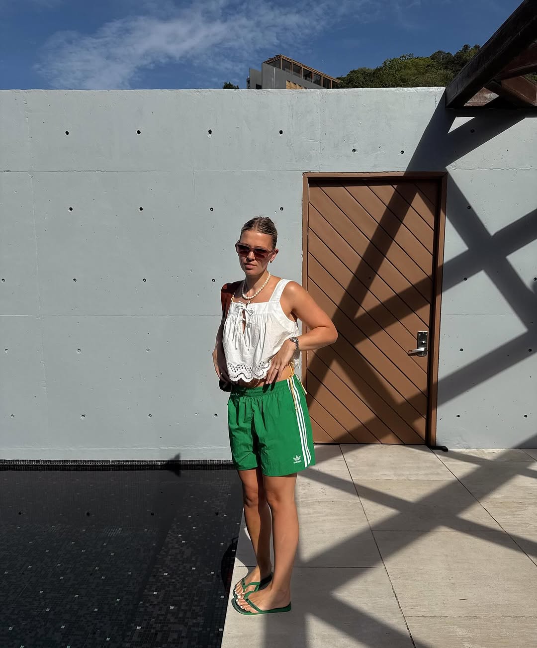 woman wearing green long shorts with white top