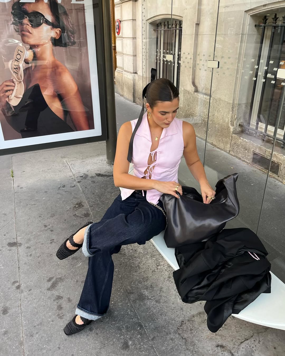 Woman wearing pink top and dark denim with ballet flats in a summer 2025 outfit.