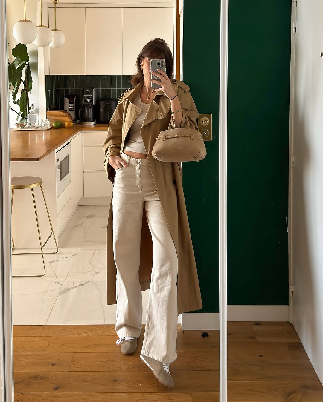 Woman wearing loose white jeans with fitted white tank.