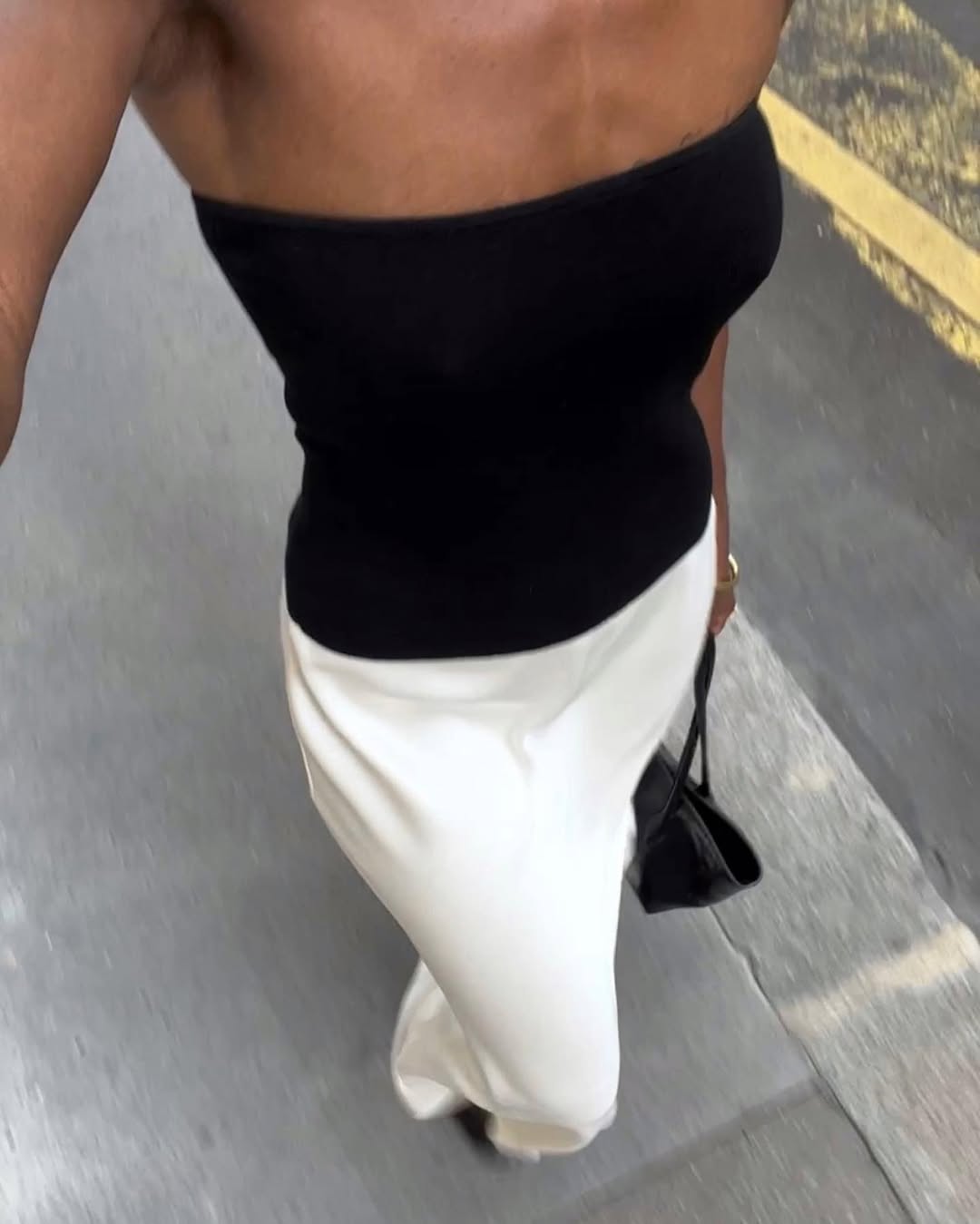 woman wearing strapless black top and white skirt