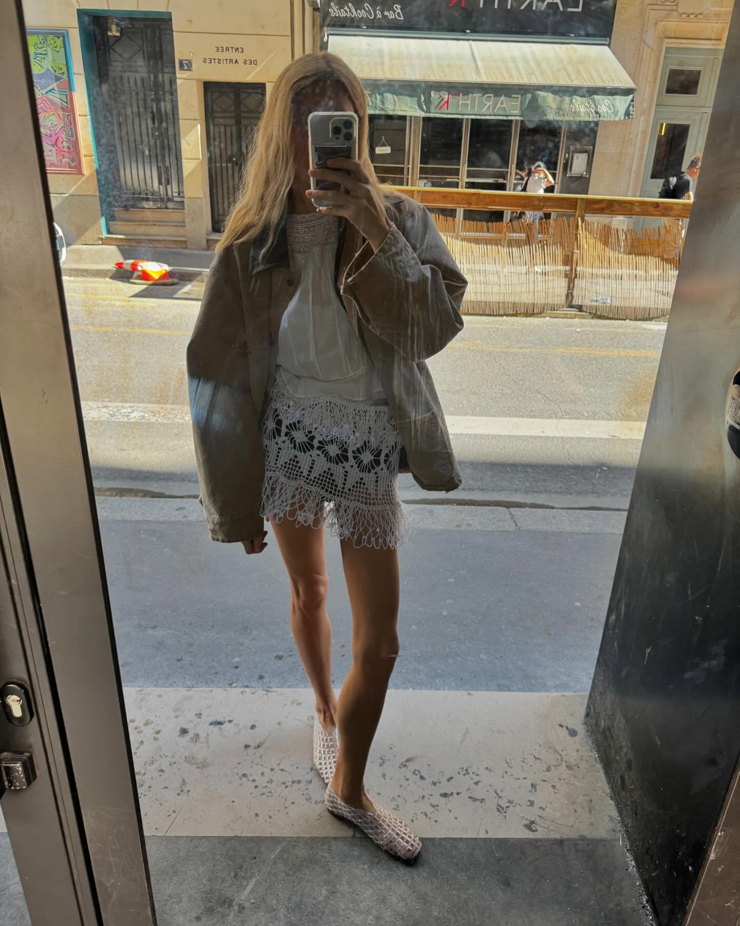 Courtney Grow wearing a leather jacket and mini crochet skirt.