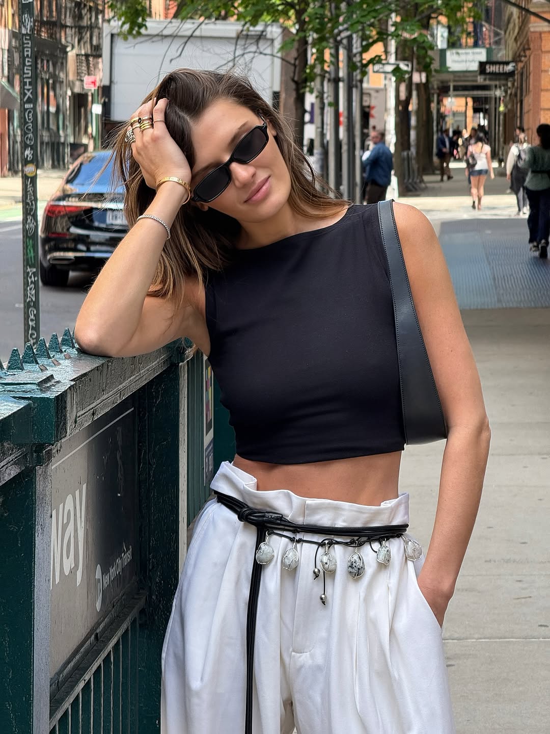 woman wearing black crop top and white pants