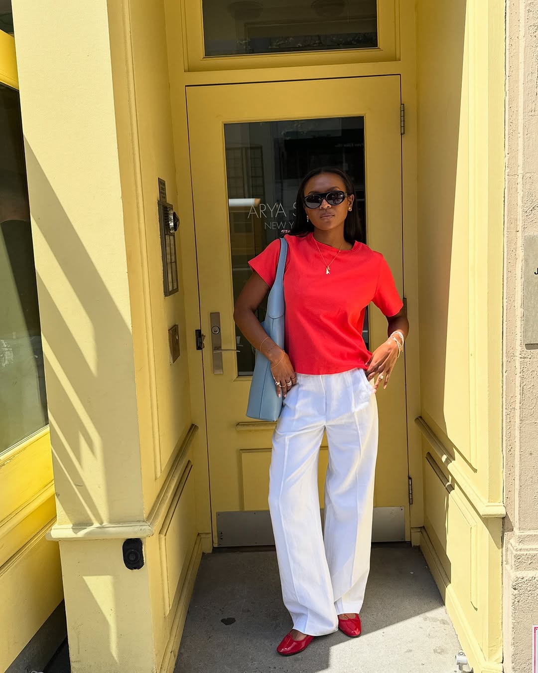 woman wearing ballet flats with white pants summer 2025