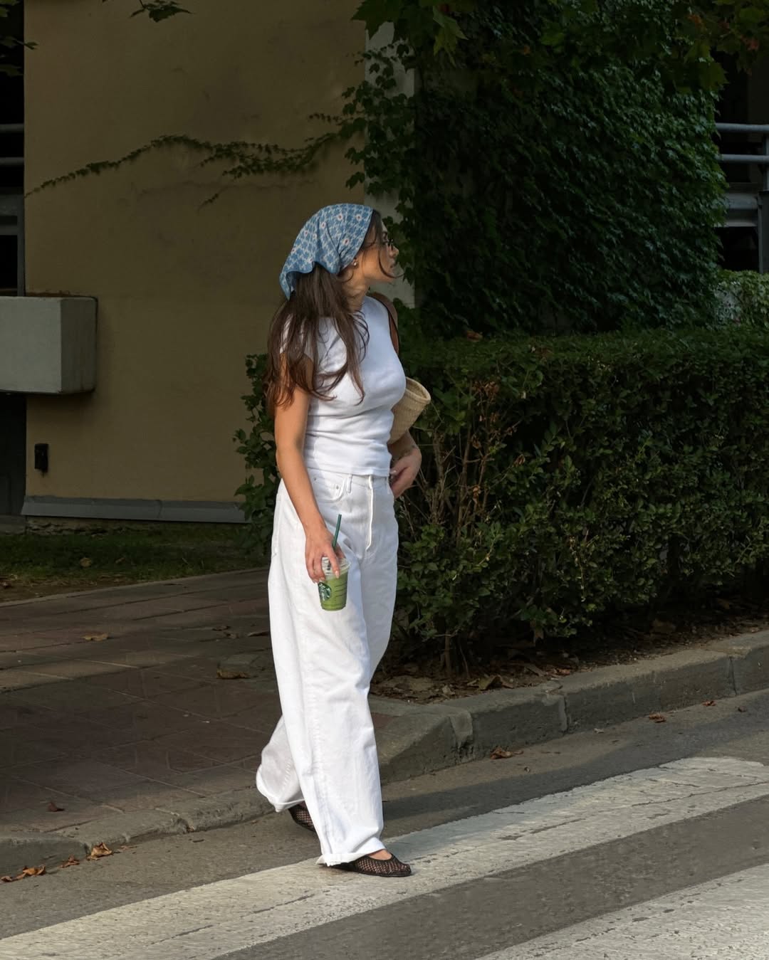 woman wearing ballet flats with white pants summer 2025