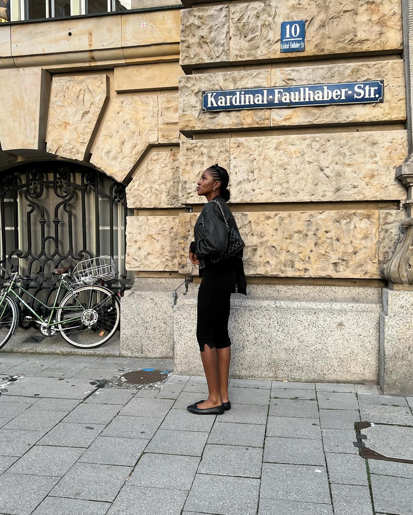 Georgia wears black ballet flats, capri pants, and a jacket.