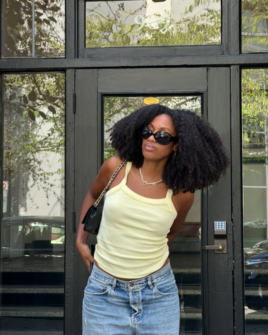 woman wearing yellow tank top summer outfit 2025