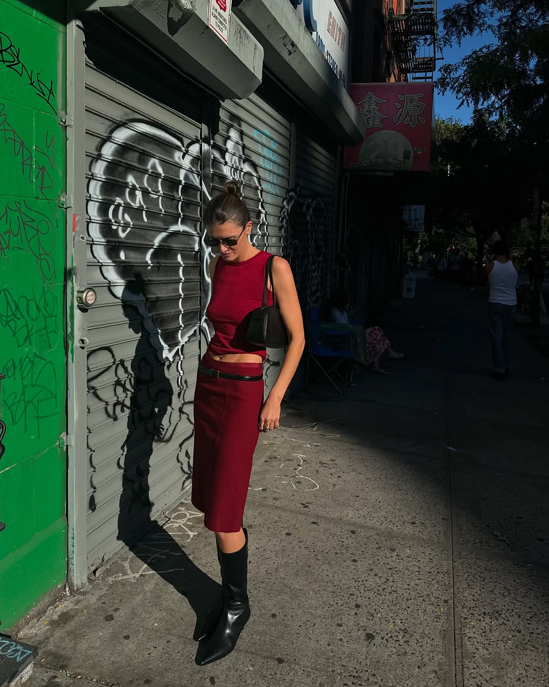 woman wearing matching red set and black leather boots