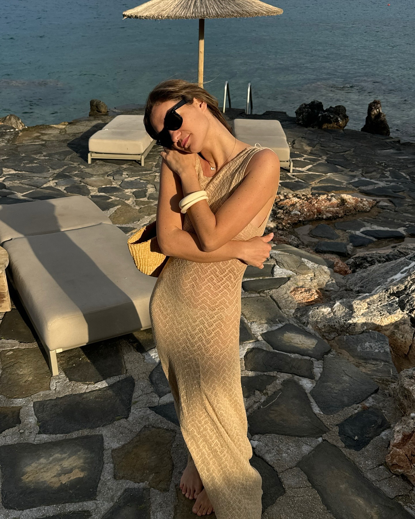 French woman wearing a crochet dress and bangle bracelets.