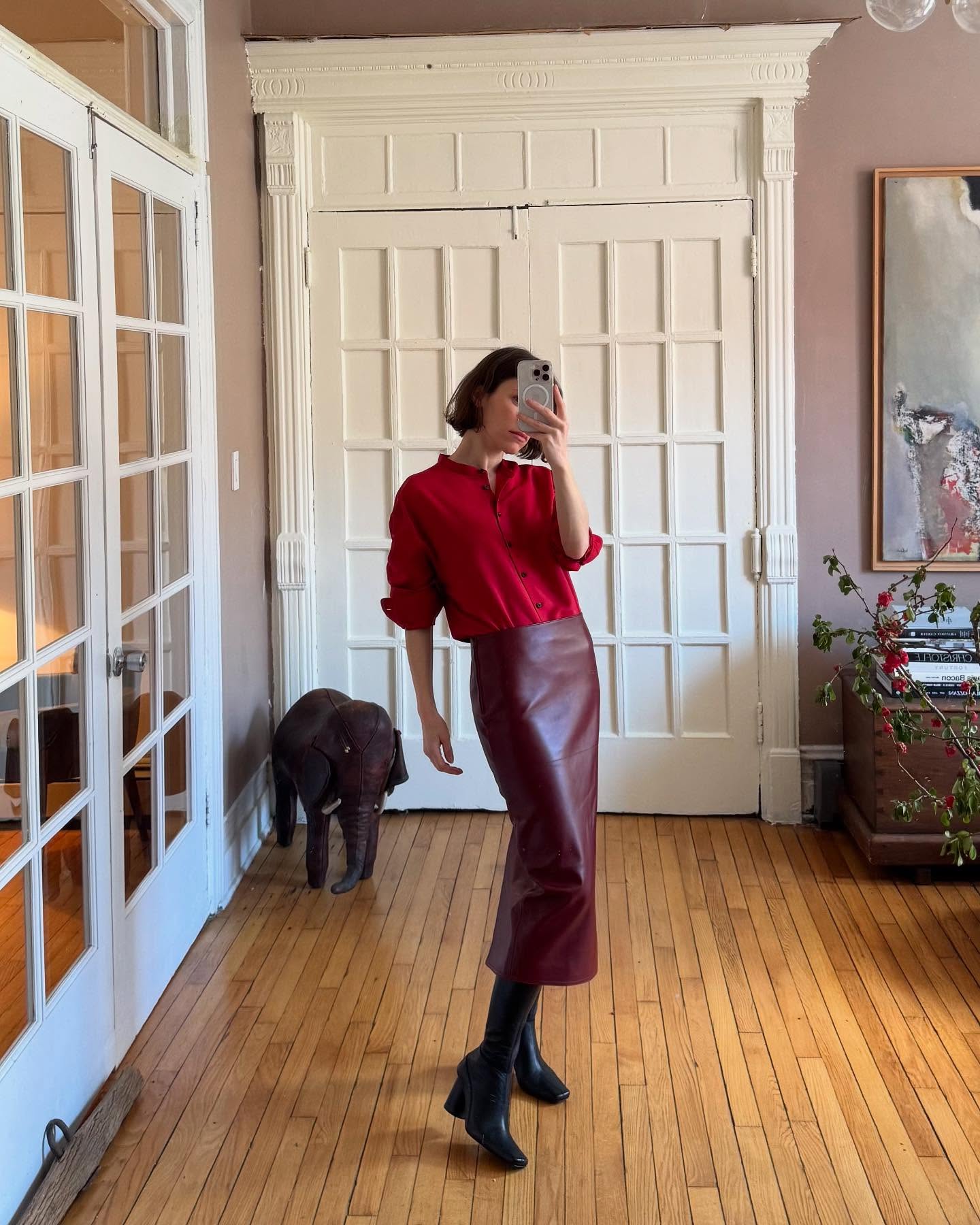 Laura Reilly wearing a red top and burgundy leather skirt.