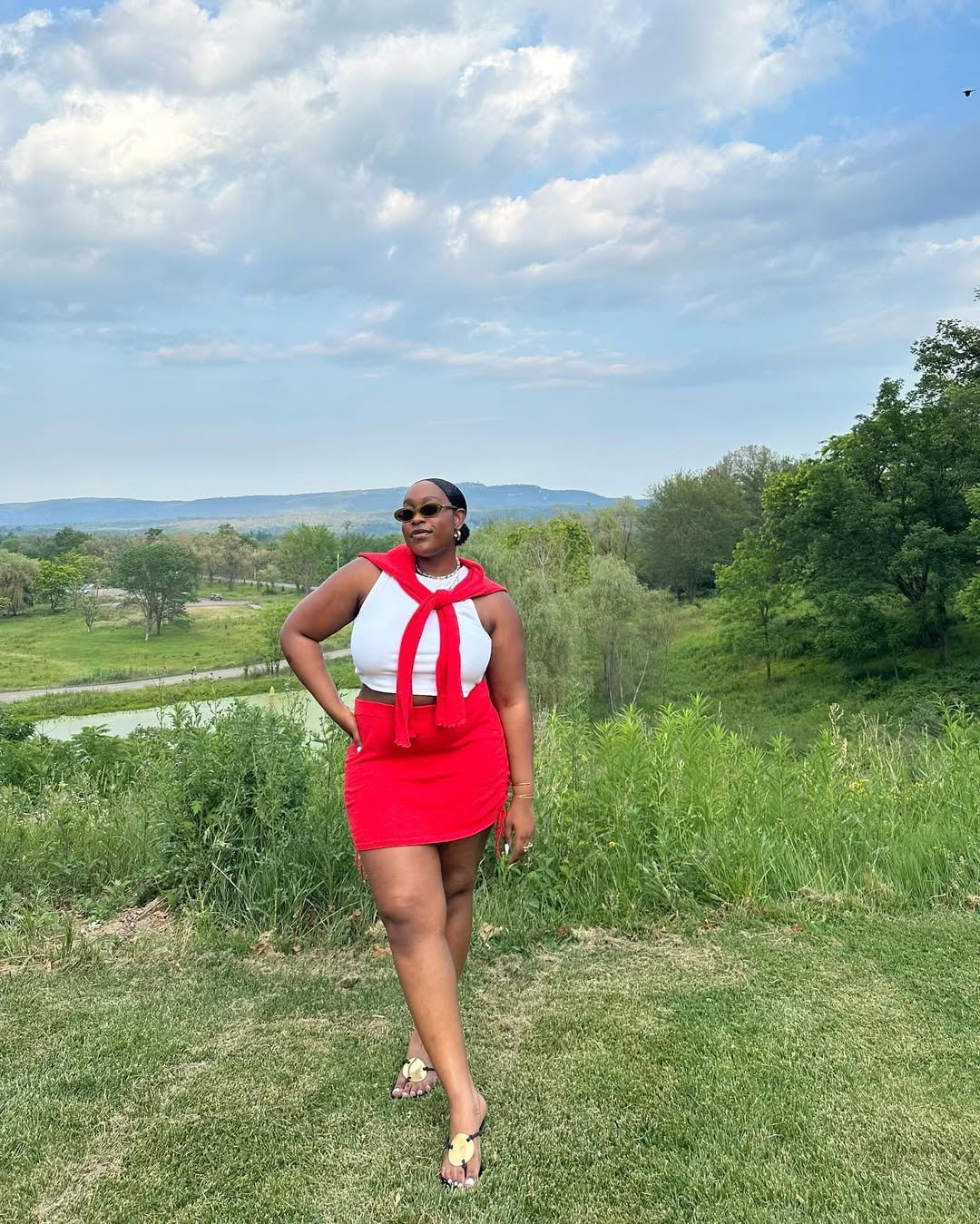 woman wearing red miniskirt and red cardigan over shoulders