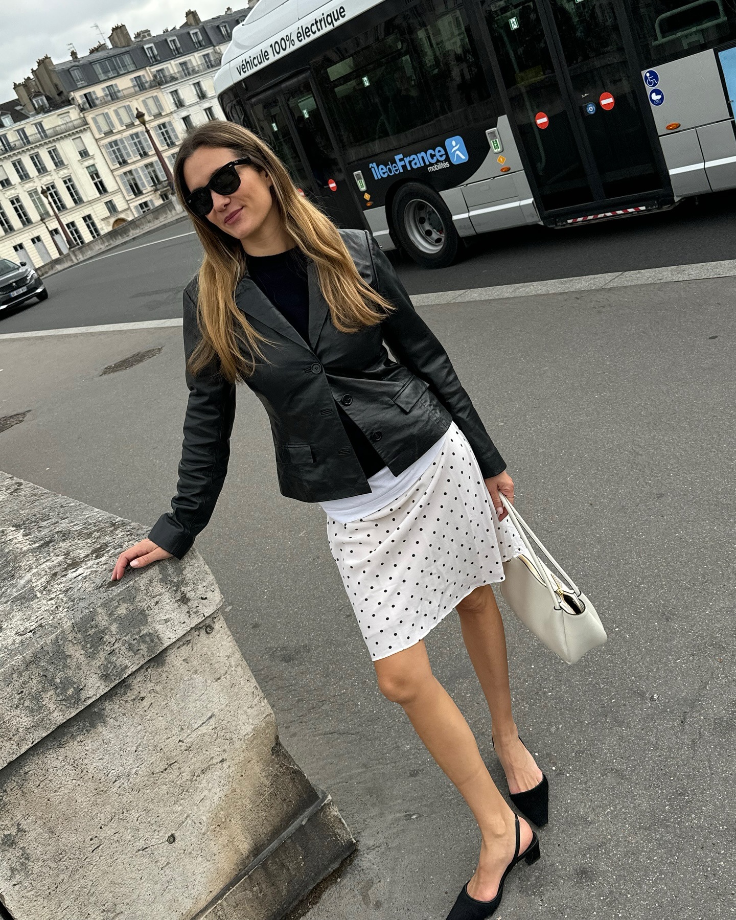 '90s-inspired outfit including a black leather blazer and polka-dot skirt