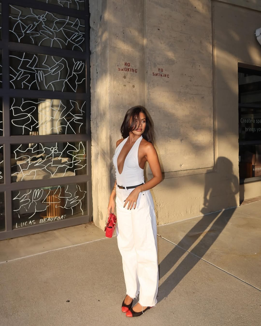 woman wearing ballet flats with white pants summer 2025