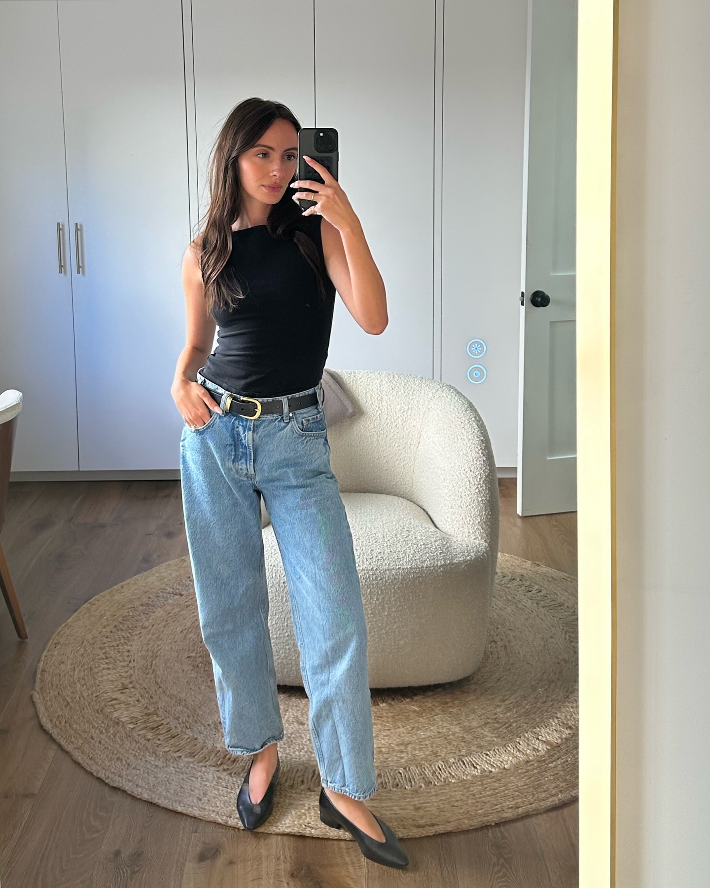 '90s-inspired outfit including a black tank top and jeans