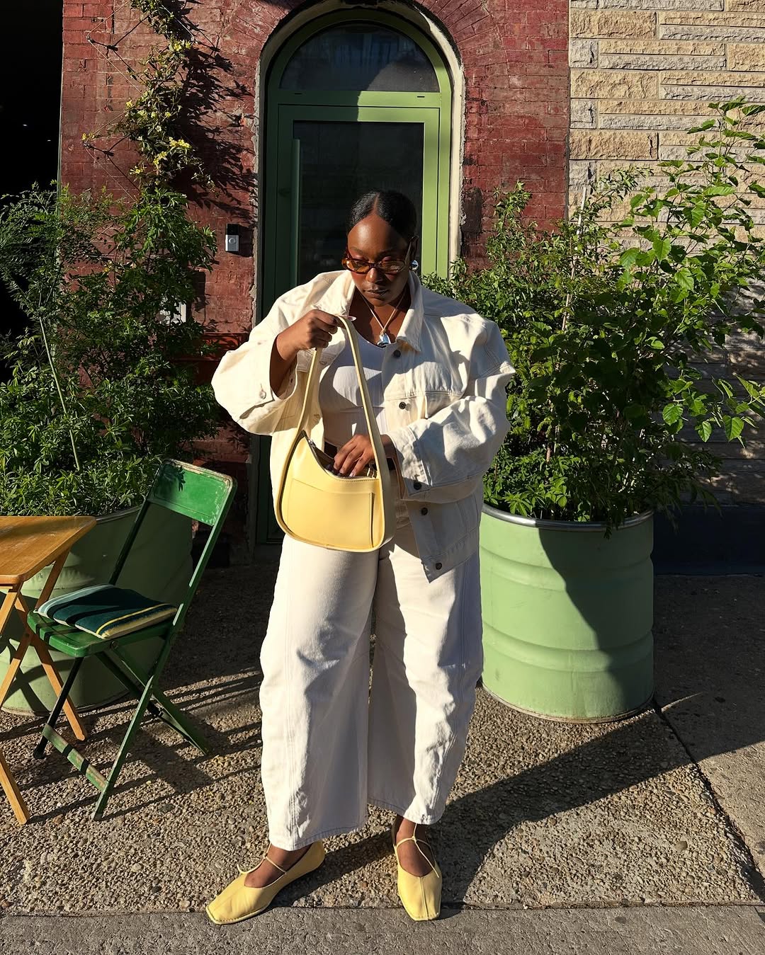 woman wearing ballet flats with white pants summer 2025