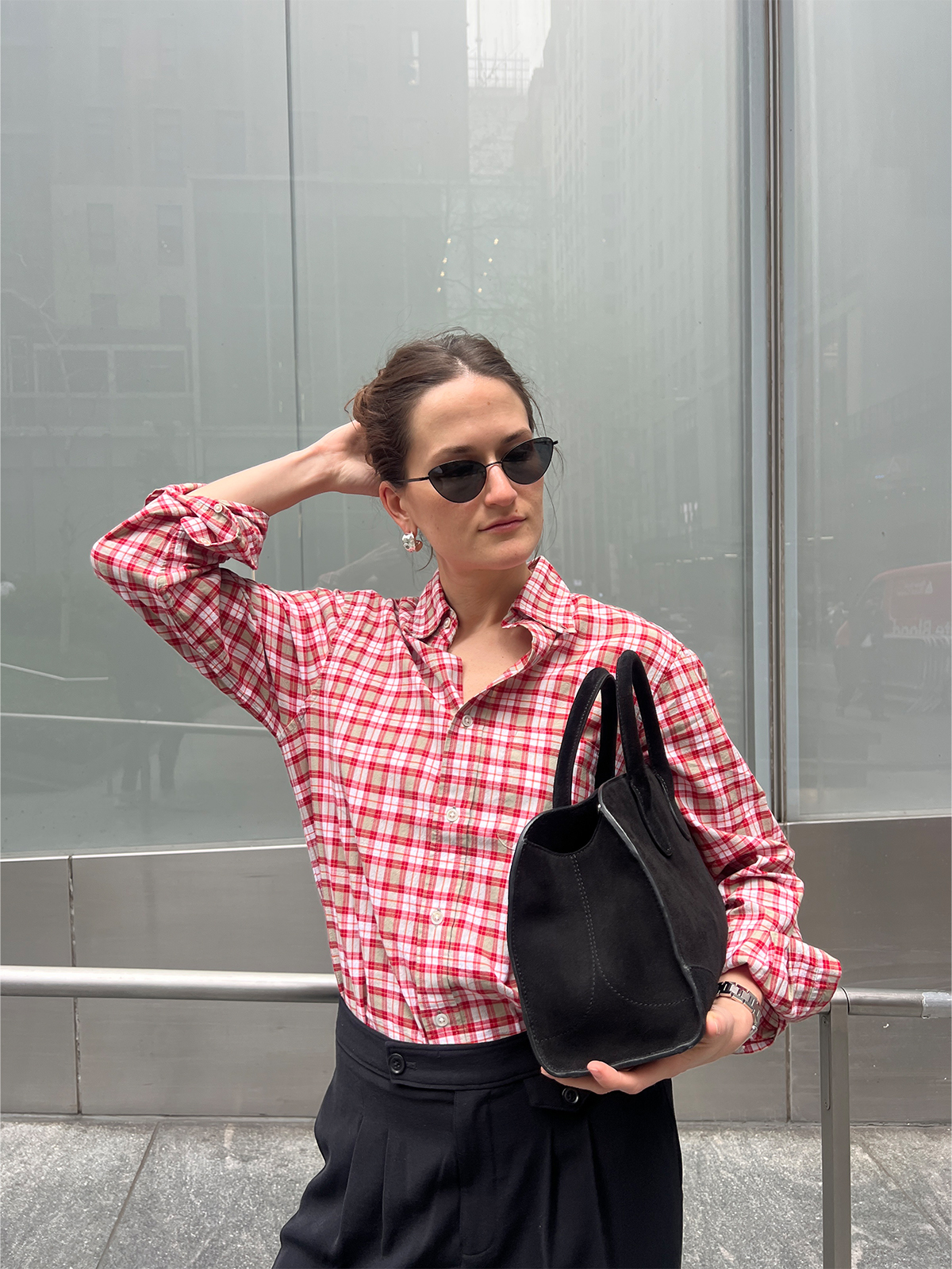Eliza Huber wearing a red plaid shirt with black trousers.