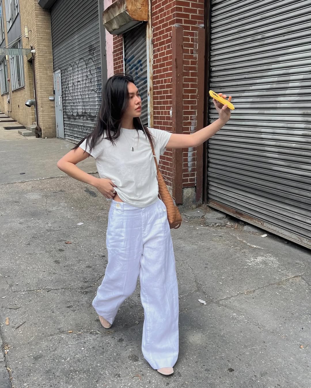 woman wearing ballet flats with white pants summer 2025