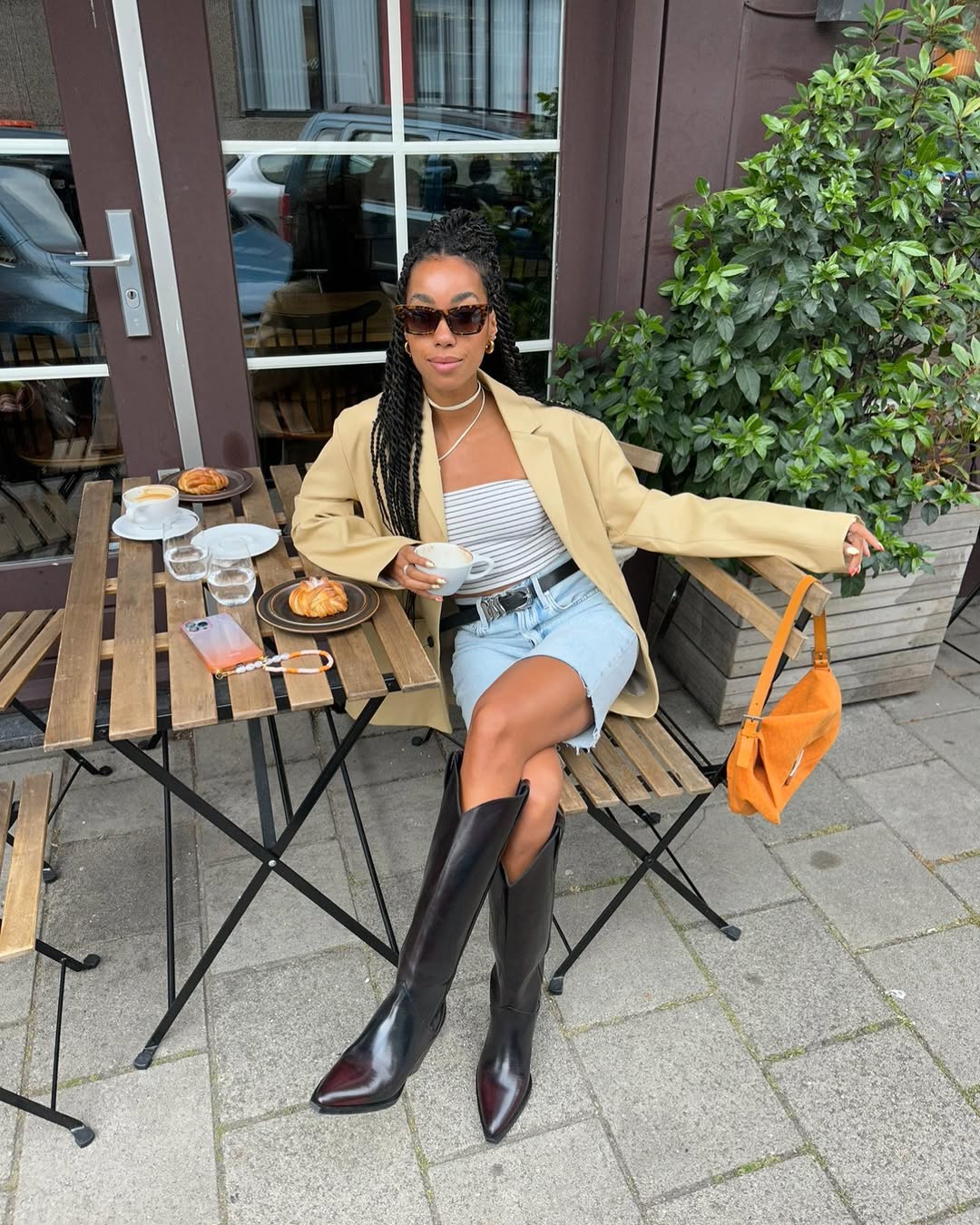 woman wearing tube top and denim shorts with black boots