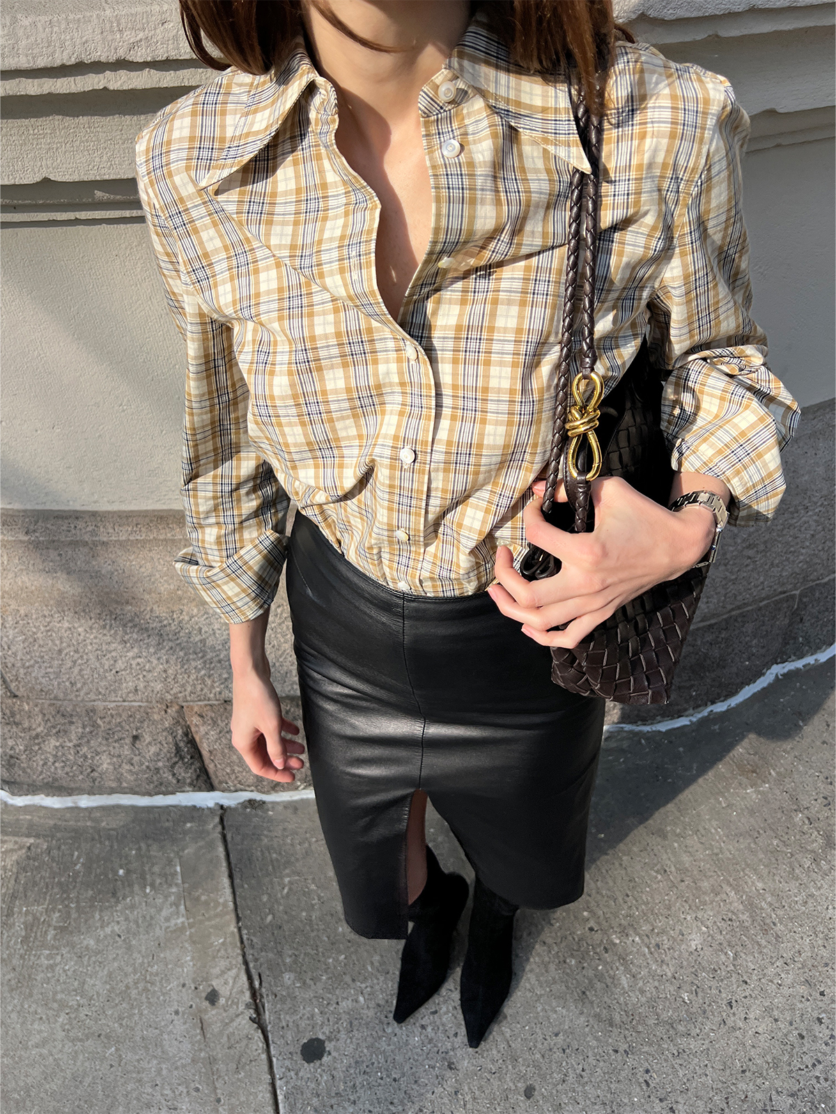 Eliza Huber wearing a tan Tory Burch plaid shirt with a leather Tom Ford for Gucci pencil skirt.