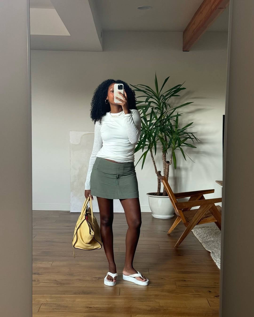 woman wearing green miniskirt with chunky white flip flops in nyc summer outfit