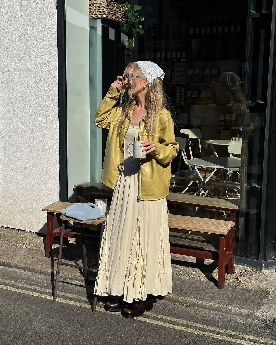 woman wearing butter yellow dress and leather jacket with white bandana
