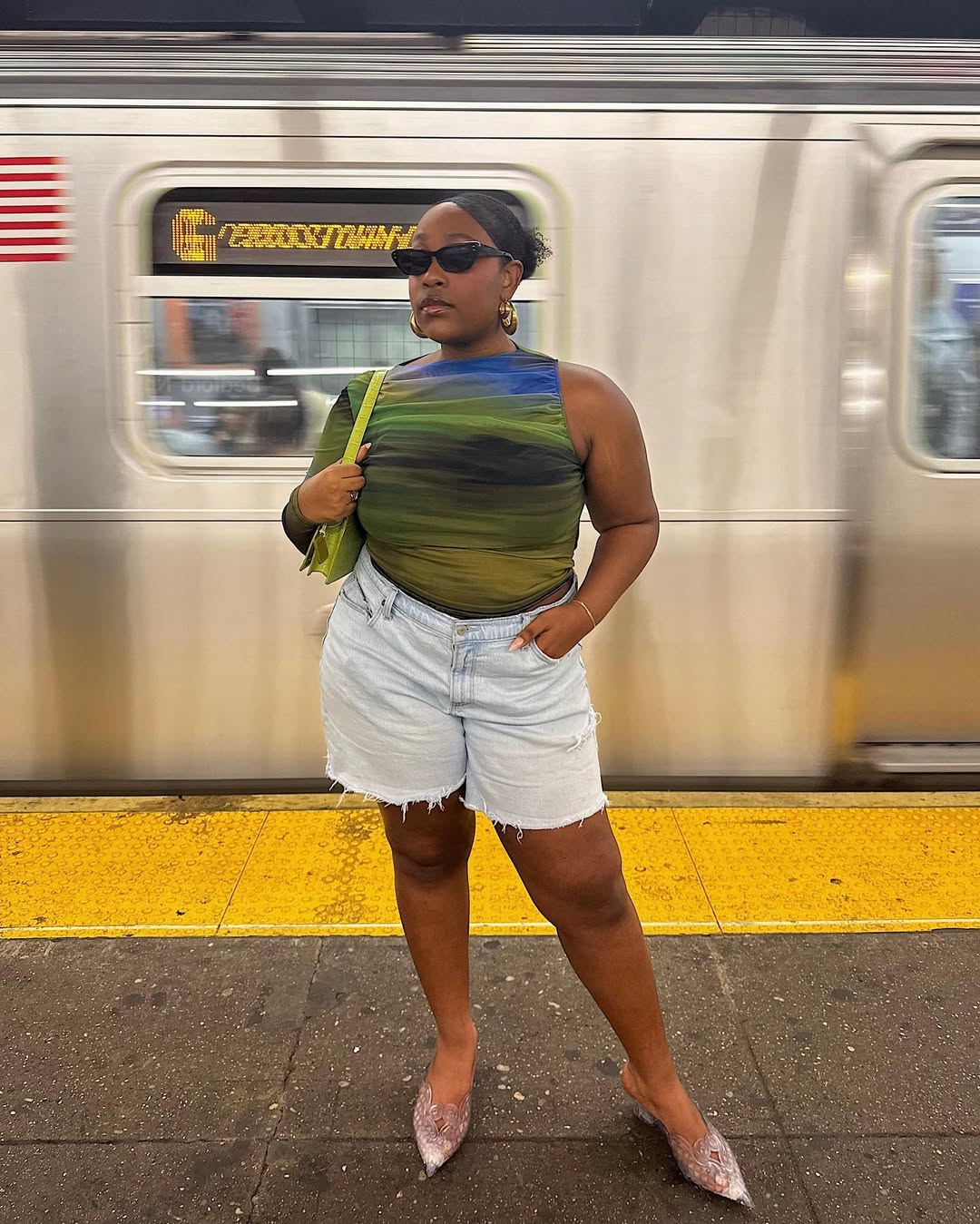 woman wearing denim shorts with pointed-toe heels in nyc summer outfit