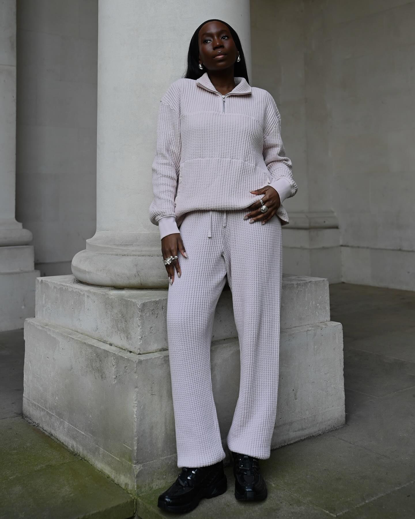 Danielle Jinadu wearing a waffle-knit set including a pullover sweater and drawstring pants.