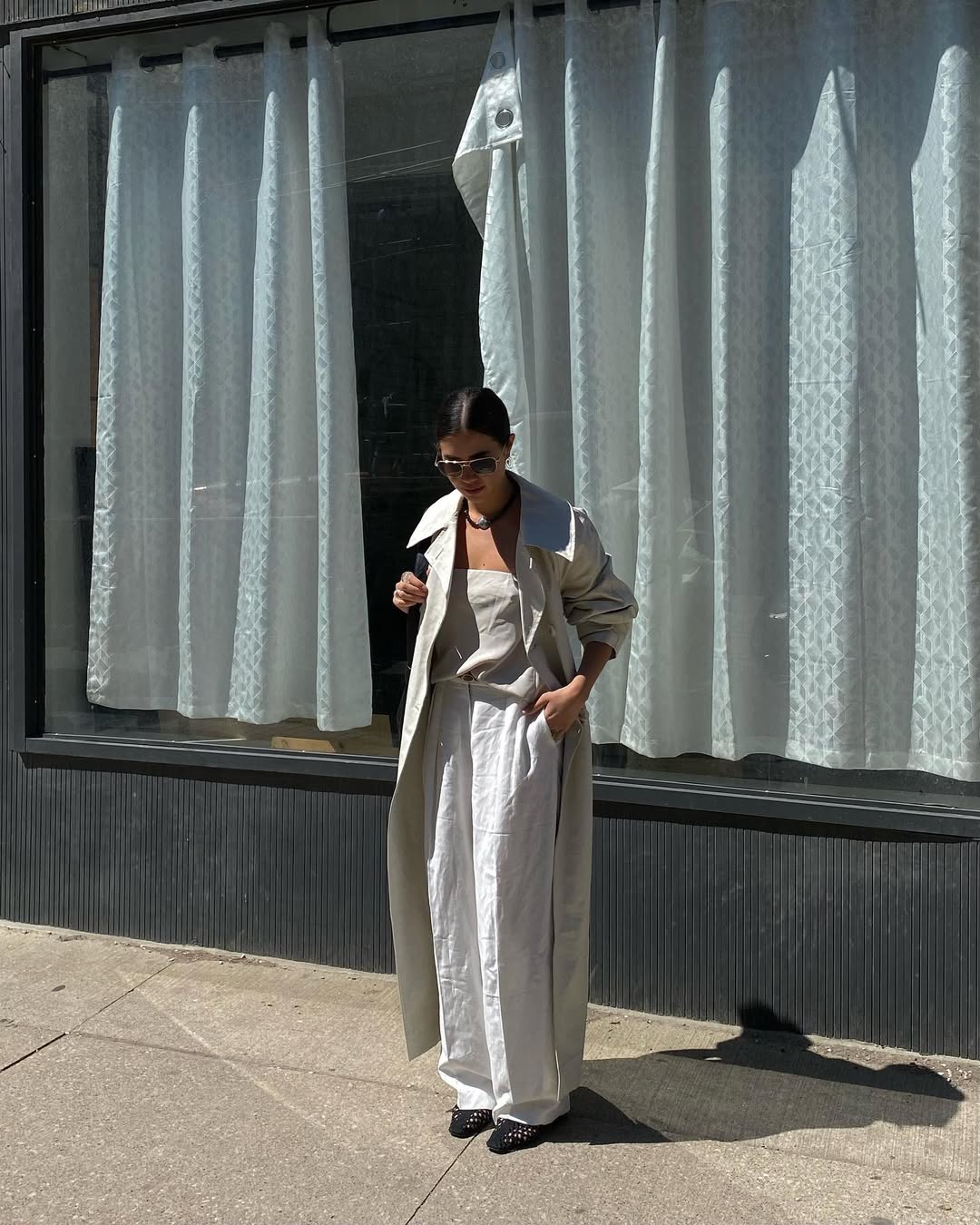 woman wearing ballet flats with white pants summer 2025