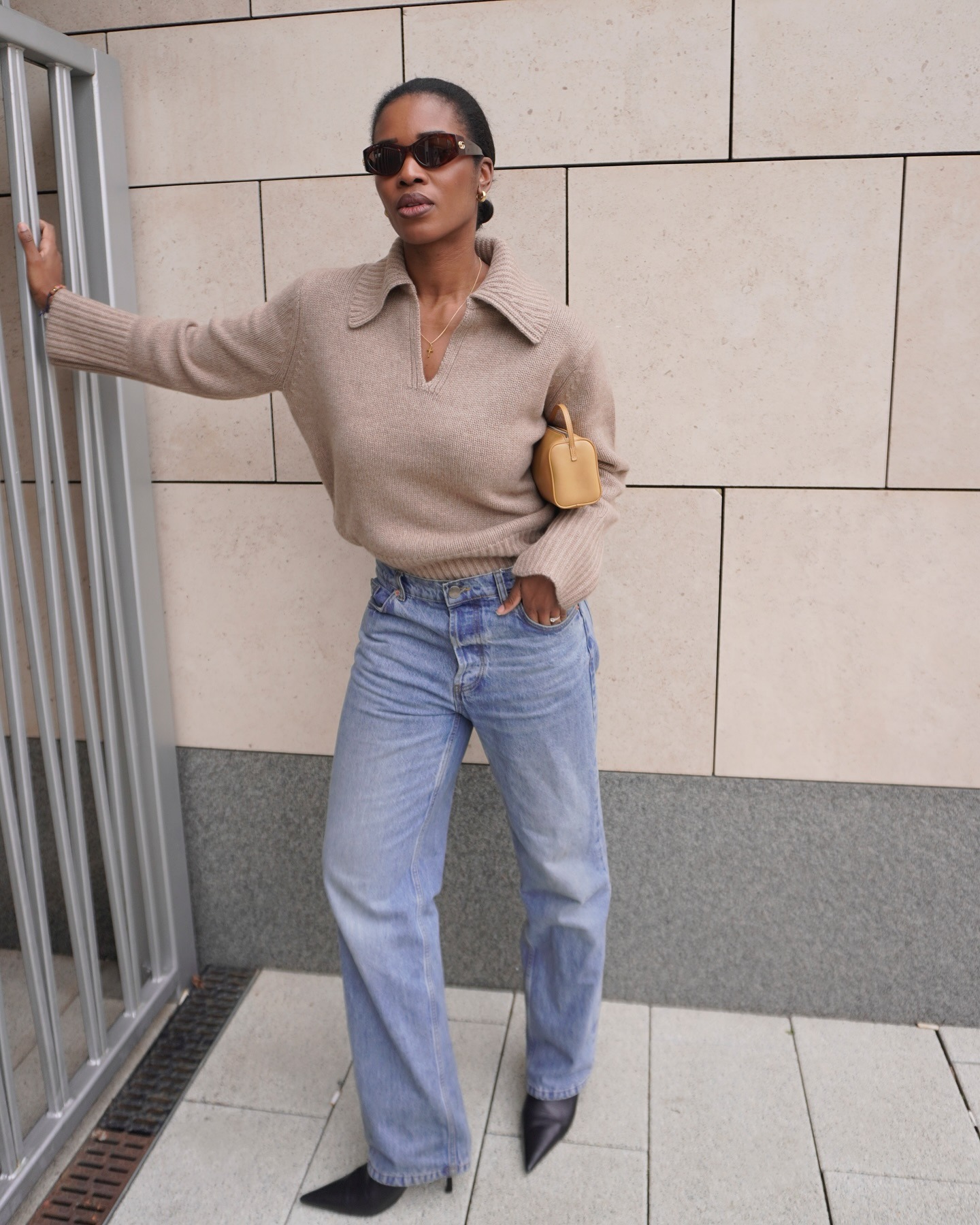 '90s-inspired outfit including a polo-neck sweater, jeans, and boots