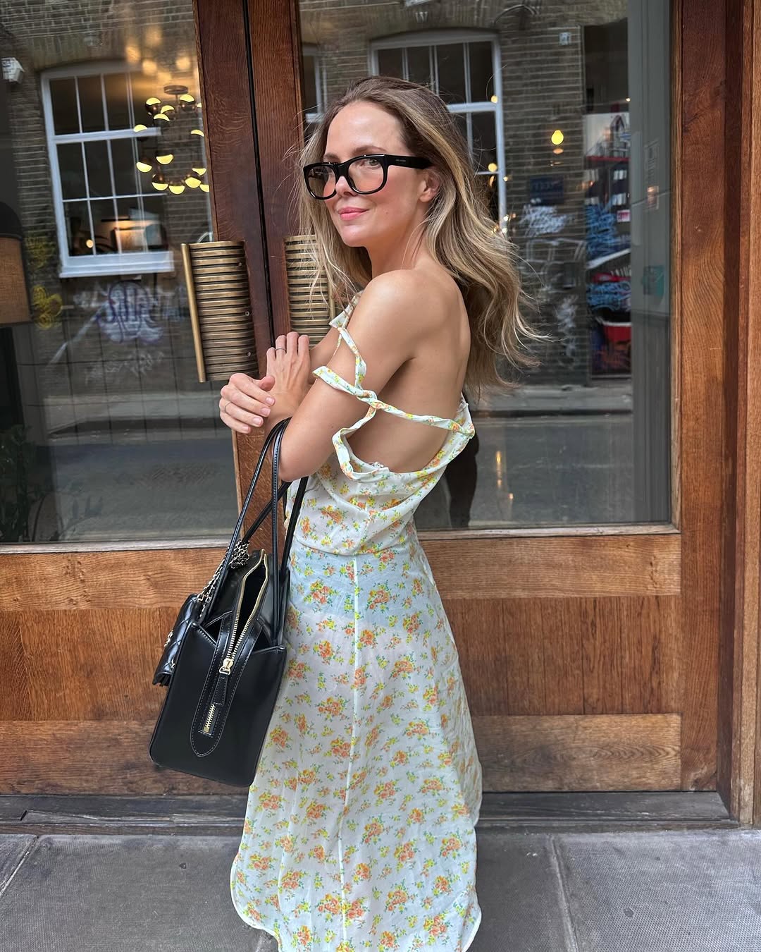 woman wearing sheer floral dress and glasses.