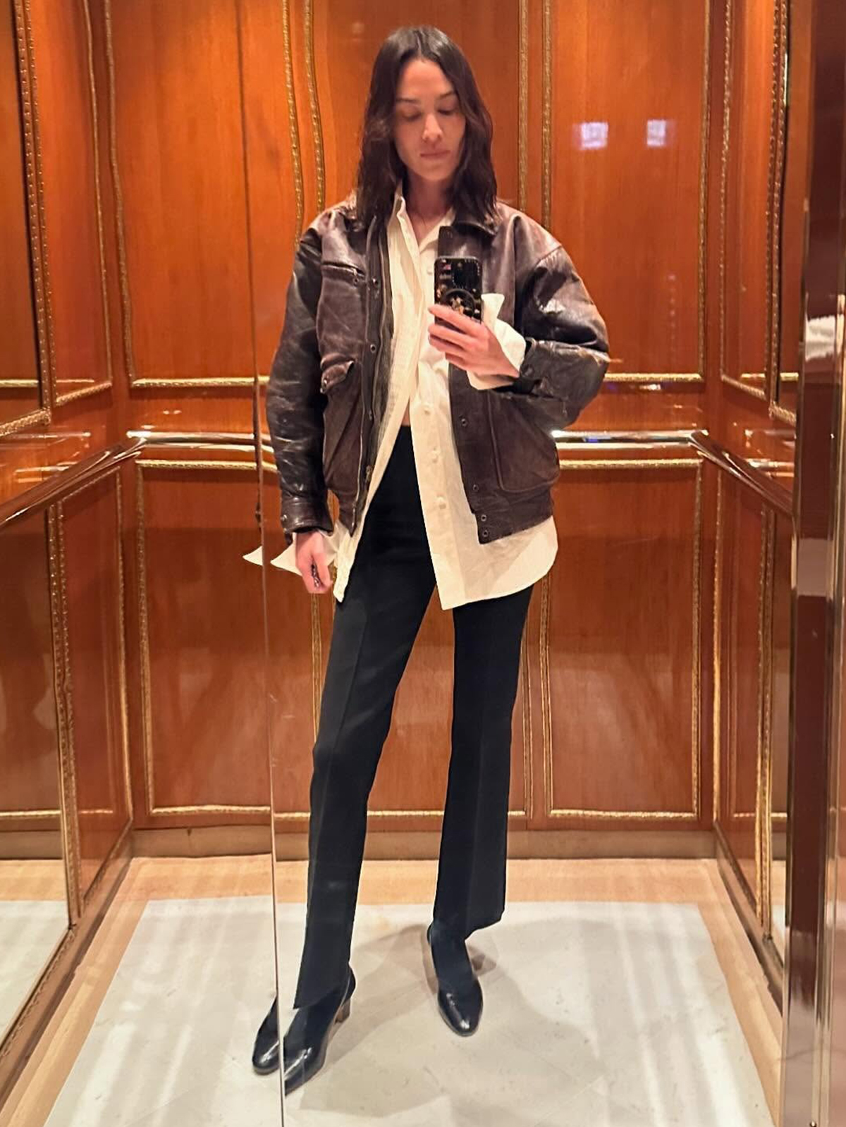 Alexa Chung wearing a leather jacket and High Sport stretchy kick flare pants.