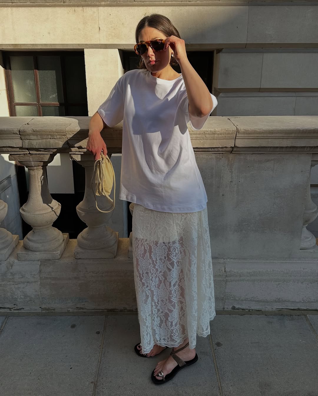 woman wearing white oversized t-shirt and lace skirt