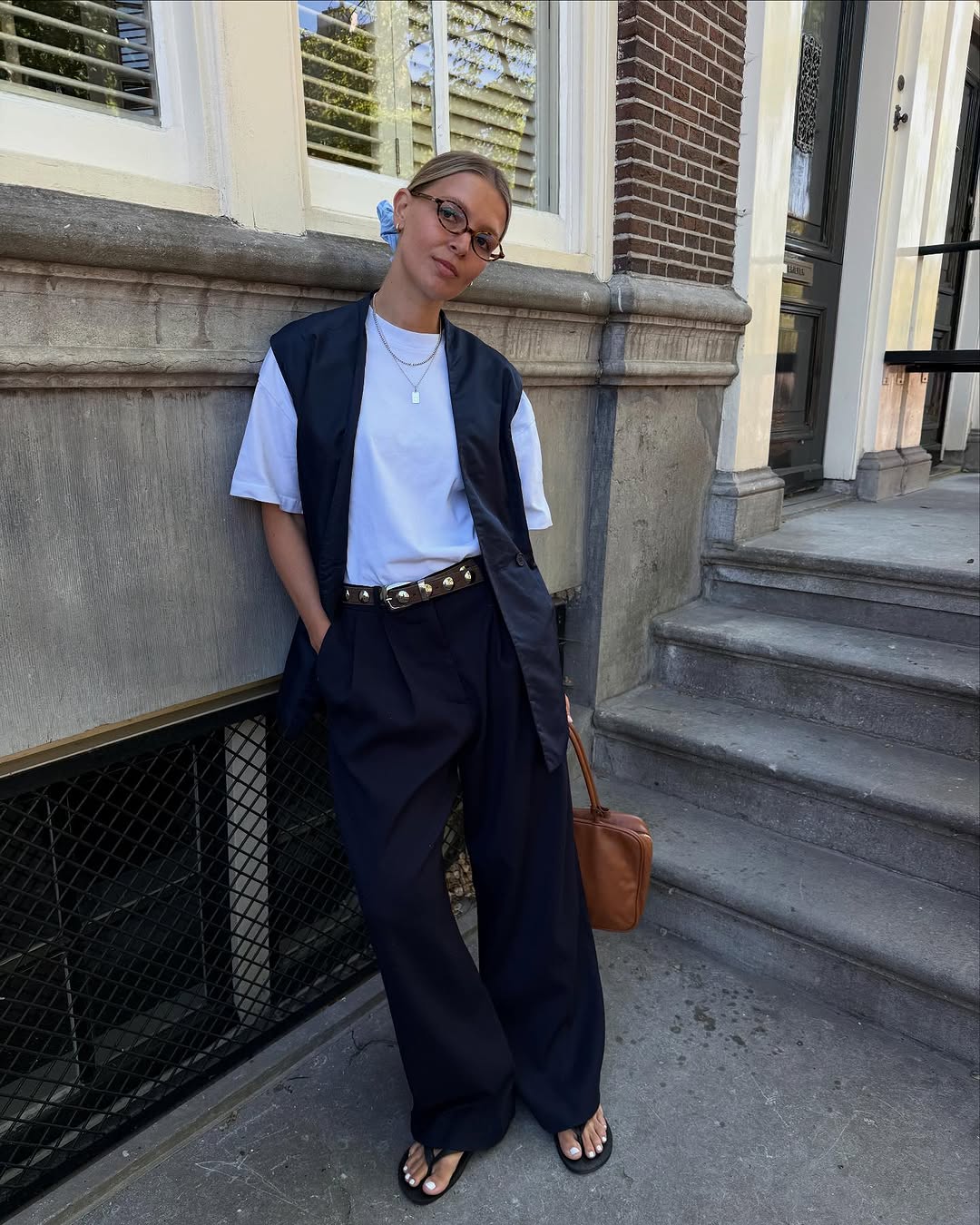 Woman wearing trouser pants and flip flops summer 2025.